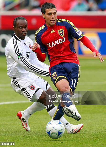 Javier Morales of Real Salt Lake takes the ball away from Francis Dope of D.C. United during the second half of MLS action at Rio Tinto Stadium April...