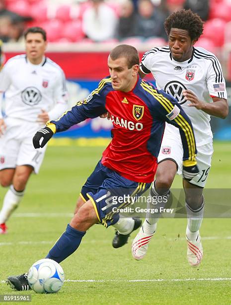 Yura Movsisyan of Real Salt Lake takes the ball down field as Clyde Simms of D.C. United gives chase during the second half of MLS action at Rio...