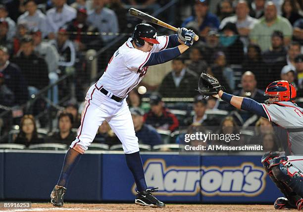 Infielder Kelly Johnson of the Atlanta Braves is hit by an inside pitch against the Washington Nationals April 10, 2009 at Turner Field in Atlanta,...