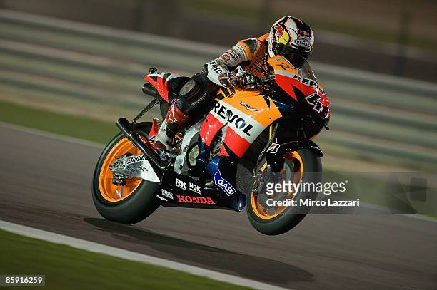 Andrea Dovizioso of Italy and Repsol Honda Team lifts the front wheel during test day two to the Motorcycle Grand Prix of Doha on April 11, 2009 in...