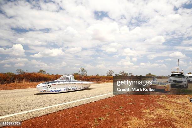 University Tokai Challenger vehicle "Tokai" from Japan passes Nuon Solar Team vehicle "Nuna9" from the Netherlands who were forced to stop as they...