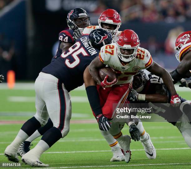 Onta Foreman of the Houston Texans runs between Christian Covington of the Houston Texans and Zach Cunningham in the second quarter at NRG Stadium on...