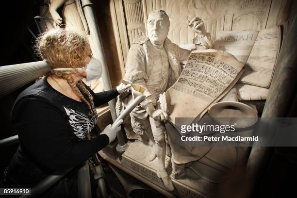 Conservator Cat Clarke cleans a statue of composer George Frideric Handel at Poets Corner in Westminster Abbey on April 8, 2009 in London. Handel,...