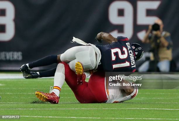 Travis Kelce of the Kansas City Chiefs takes a hit from Marcus Gilchrist of the Houston Texans after catching a pass in the second quarter at NRG...