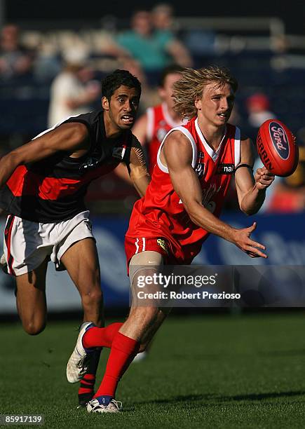 Dennis Armfield of the Bullants handballs during the round one VFL match between the Northern Bullants and the Bendigo Bombers at Visy Park on April...