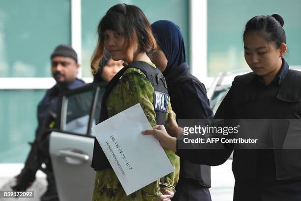 Vietnamese defendant Doan Thi Huong is escorted by police personnel following her arrival at the Malaysian Chemistry Department in Petaling Jaya,...