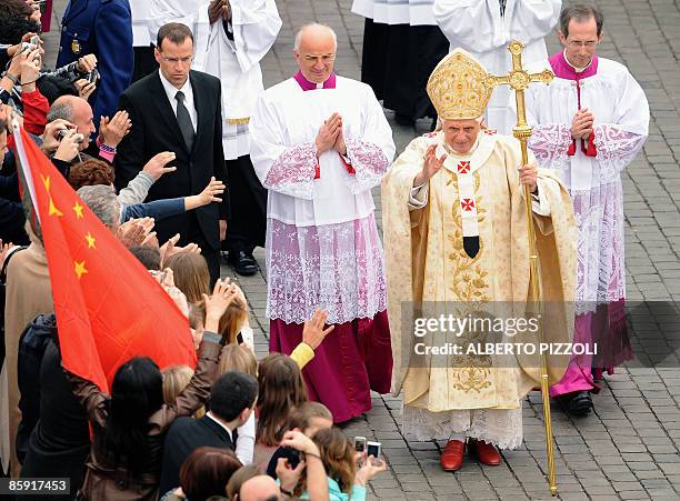 Faithful waves a Chinese flag as Pope Benedict XVI arrives to celebrate Easter mass on April 12 at St Peter's square at the Vatican. The mass will be...