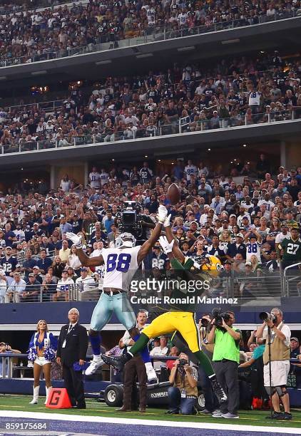 Dez Bryant of the Dallas Cowboys jumps for a pass against Davon House of the Green Bay Packers at AT&T Stadium on October 8, 2017 in Arlington, Texas.