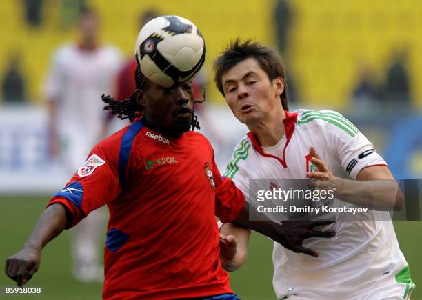 Chidi Odiah of PFC CSKA Moscow battles for the ball with Diniyar Bilyaletdinov of FC Lokomotiv Moscow during the Russian Football League Championship...