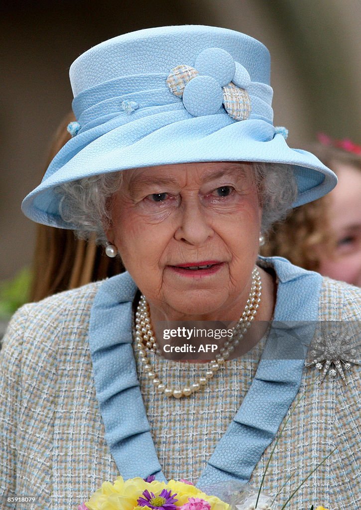 Britains Queen Elizabeth II (C) leaves a