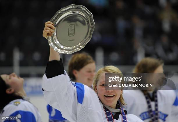 Finland's Captain Emma Laaksonen celebrates after winning the Bronze medal against Sweden during the Women Ice Hockey World Championship in...