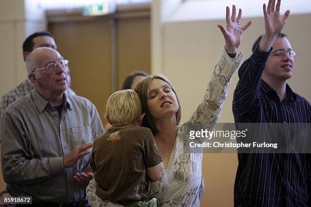 Customers and friends of Cafe Life on the Blacon estate take part in an Easter Sunday Miracle Service in a hall next to the cafe on April 12, 2009 in...