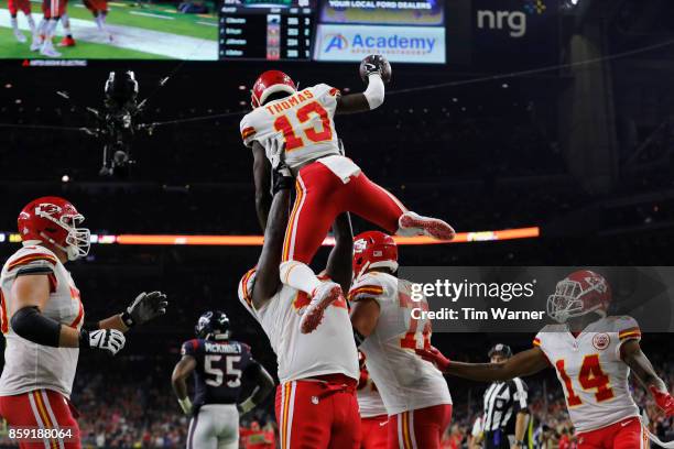 Cameron Erving of the Kansas City Chiefs lifts De'Anthony Thomas in celebration after a touchdown in the third quarter at NRG Stadium on October 8,...