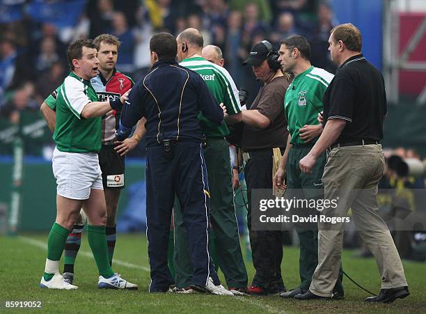 Nick Evans of Harlequins is brought back onto the field to replace the injured Tom Williams as referee Nigel Owens talks to Harlequins Coach Dean...