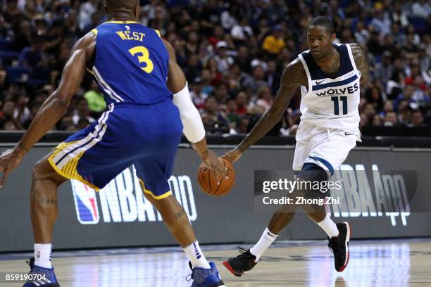 Jamal Crawford of the Minnesota Timberwolves in action against David West of the Golden State Warriors during the game between the Minnesota...