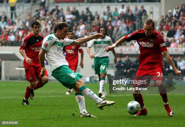 Clemens Fritz of Bremen shoots on goal during the Bundesliga match between Bayer Leverkusen and Werder Bremen at the LTU Arena on April 12, 2009 in...