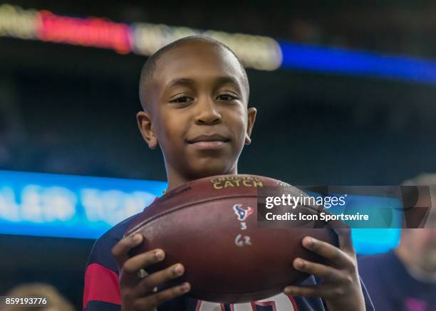 Houston Texans wide receiver DeAndre Hopkins gives the touchdown ball to his nephew Anthony Scott during the football game between the Kansas City...