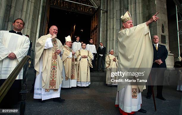 Cardinal Edward Egan points to the crowd gathered outside St. Patrick's Cathedral after celebrating his final Easter mass as archbishop of the Roman...