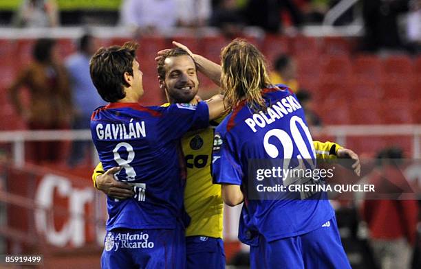 Getafe's players Jaime Gavilan, Roberto Soldado and Eugen Polanski celebrate after winning a Spanish league football match against Sevilla at the...