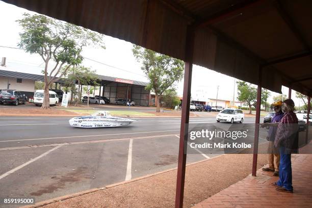 Locals watch on as University Tokai Challenger vehicle "Tokai" from Japan races in the Challenger Class passes through the Tennant Creek on Day 2 of...