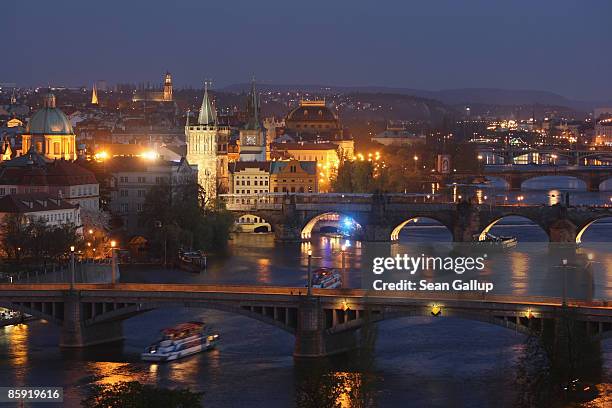 The Moldau River flows under the Charles Bridge and past buildings in Old Town on April 12, 2009 in Prague, Czech Republic. Prague is among Europe's...