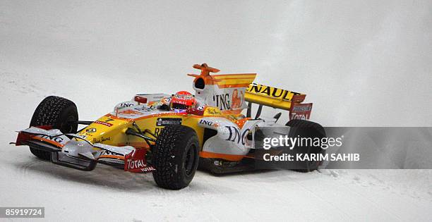 Renault's Brazilian Formula One driver Nelson Piquet displays his driving skills during a promotional event for the car manufacturer at the indoor...