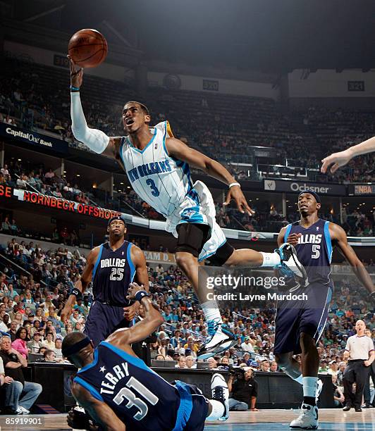 Chris Paul of the New Orleans Hornets shoots over Jason Terry, Erick Dampier and Josh Howard of the Dallas Mavericks on April 12, 2009 at the New...