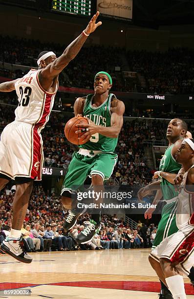 Rajon Rondo of the Boston Celtics shoots against LeBron James of the Cleveland Cavaliers during a game on April 12, 2009 at the Quicken Loans Arena...