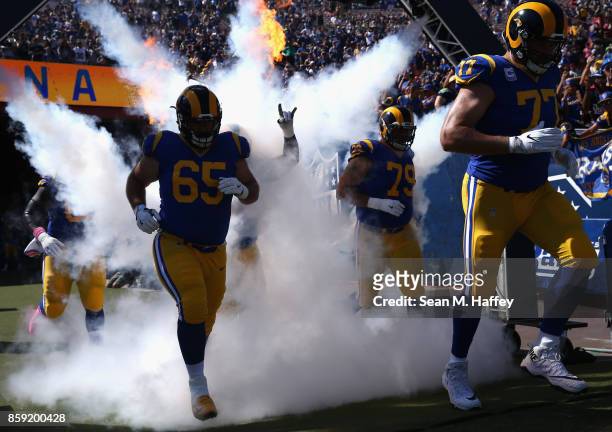John Sullivan, Andrew Whitworth and Rob Havenstein of the Los Angeles Rams take the field prior to a game against the Seattle Seahawks at Los Angeles...
