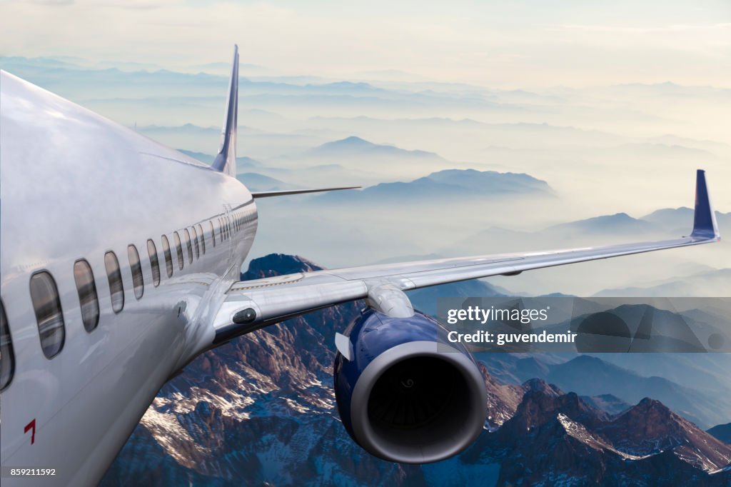 Body of an Airplane Flying Above Cloud at dusk