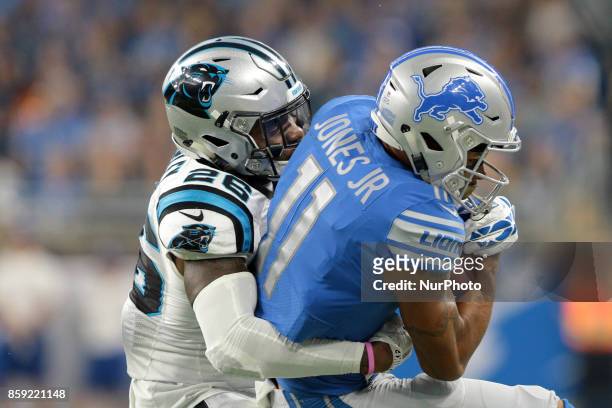 Detroit Lions wide receiver Marvin Jones is tackled by Carolina Panthers cornerback Daryl Worley during the first half of an NFL football game in...