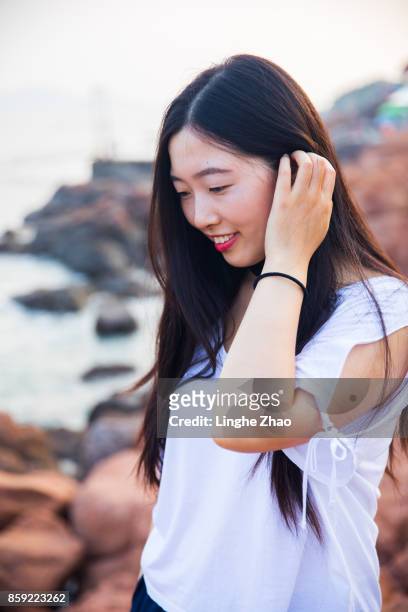 young asian woman at coastline - linghe zhao stock pictures, royalty-free photos & images