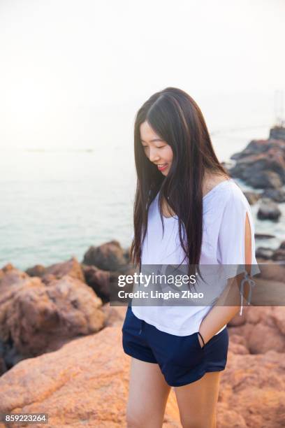 young asian woman at coastline - linghe zhao stock pictures, royalty-free photos & images