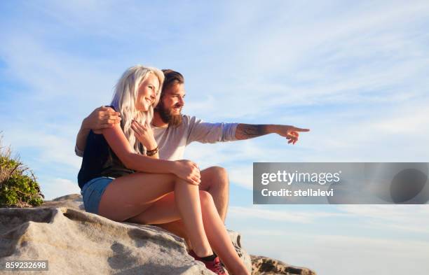 young couple enjoying nature - bondi beach sign stock pictures, royalty-free photos & images