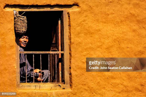 man in a window - annapurna conservation area fotografías e imágenes de stock