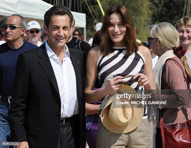 French President Nicolas Sarkozy and wife First Lady Carla Bruni-Sarkozy arrive with Marisa Bruni-Tedeschi , Carla Sarkozy's mother, to attend the...