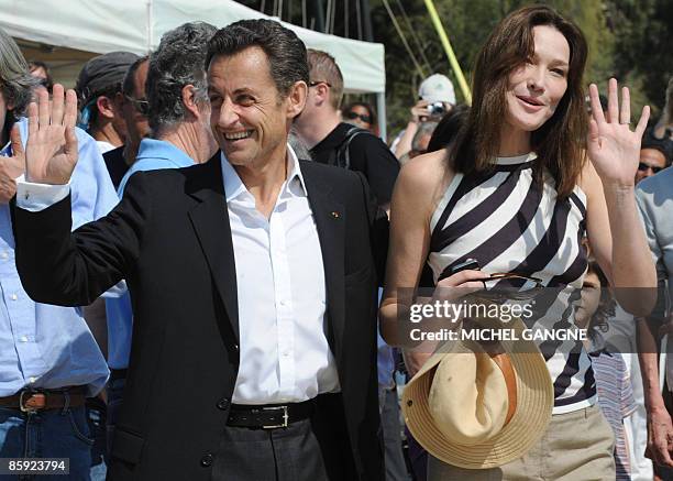 French President Nicolas Sarkozy and wife, First Lady Carla Bruni-Sarkozy wave upon arrival to attend the trophy ceremony of the first edition of the...