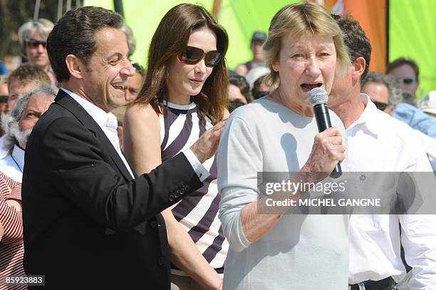 French President Nicolas Sarkozy and wife, First Lady Carla Bruni-Sarkozy listen to Marisa Bruni-Tedeschi , Carla Sarkozy's mother, as attending the...