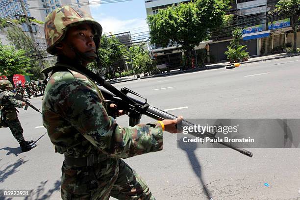 Members of the Thai military take over the streets as gun battles break out during violent protests on April 13, 2009 in Bangkok, Thailand....