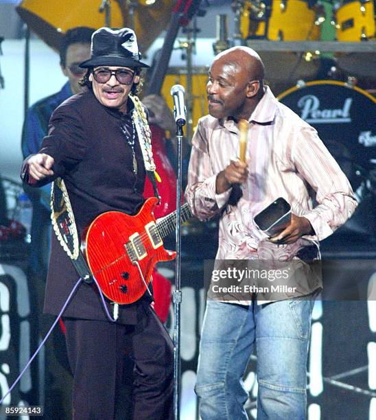 Music artist Carlos Santana and singer Tony Lindsay perform during Andre Agassi's Grand Slam for Children benefit concert at the MGM Grand Garden...