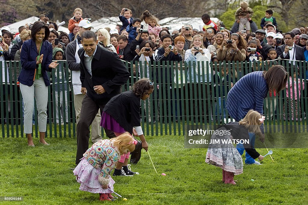First Lady Michelle Obama (L) applauds a