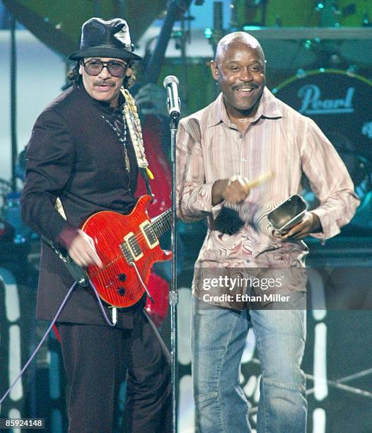 Music artist Carlos Santana and singer Tony Lindsay perform during Andre Agassi's Grand Slam for Children benefit concert at the MGM Grand Garden...