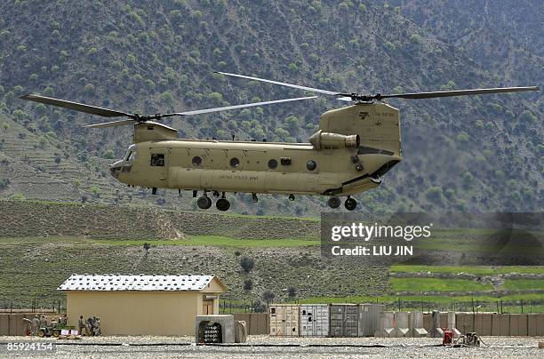 Army CH-47 Chinook helicopter takes off from the ISAF's Camp Bostick in Naray, in Afghanistan's eastern Kunar province on April 13, 2009. US...