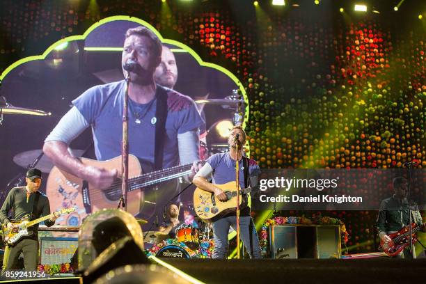 Musicians Jonny Buckland, Will Champion, Chris Martin, and Guy Berryman of Coldplay perform on stage at SDCCU Stadium on October 8, 2017 in San...