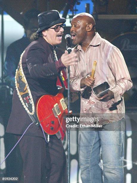 Music artist Carlos Santana and singer Tony Lindsay perform during Andre Agassi's Grand Slam for Children benefit concert at the MGM Grand Garden...