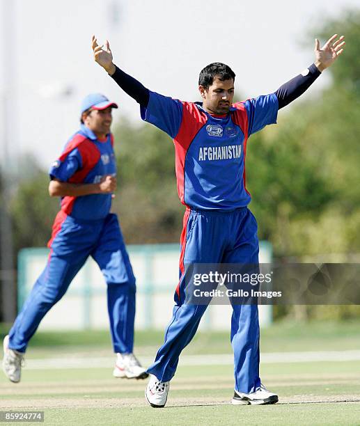 Mohammad Nabi Eisakhad of Afghanistan celebrates after claiming a wicket during the ICC Mens Cricket World Cup qualifier match between Canada and...