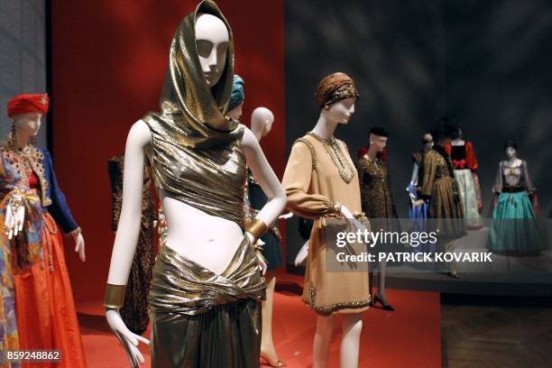 Models are displayed during an exhibition dedicated to Yves Saint-Laurent on March 8, 2010 at the Petit Palais in Paris. The world of Yves...