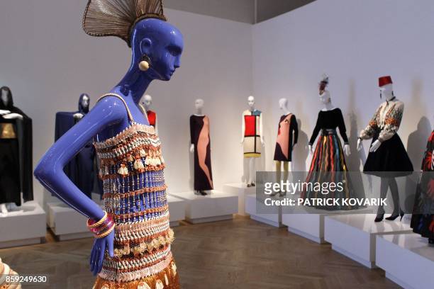 Models are displayed during an exhibition dedicated to Yves Saint-Laurent on March 8, 2010 at the Petit Palais in Paris. The world of Yves...