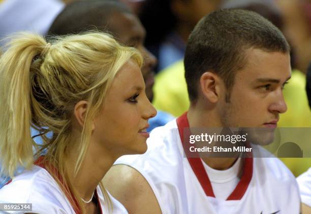 Singer Britney Spears and her boyfriend, Justin Timberlake of 'N Sync, watch from the sidelines during the celebrity basketball game at the pop...