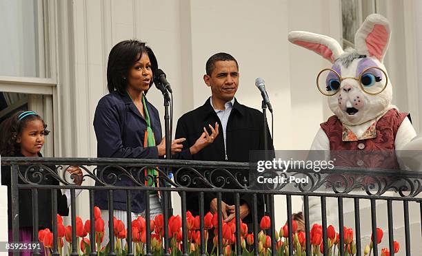 President Barack Obama , first lady Michelle Obama , and their daughter Sasha Obama welcome people to the annual White House Easter Egg Roll on the...